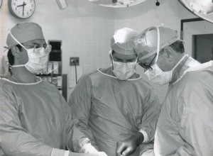 Dr. Frank Fleming performing surgery with his father and brother. 